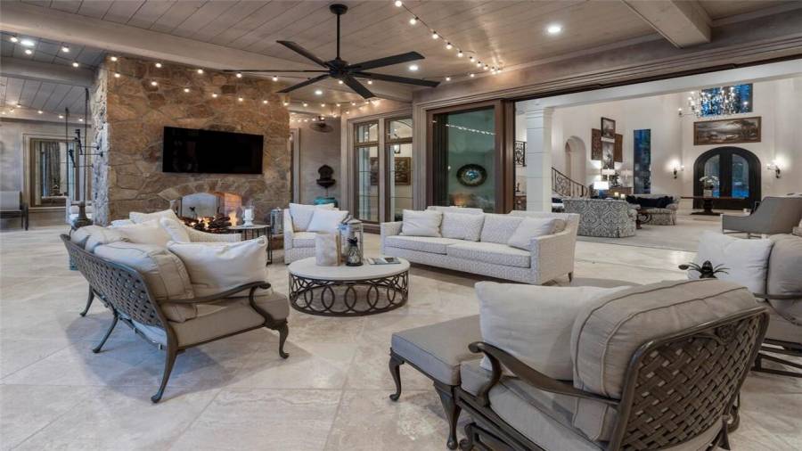 Glass doors open all the way to integrate living spaces with the outdoors.