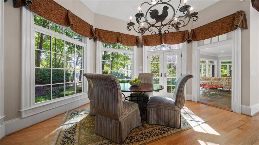 Incredible dining space within the kitchen.  Antique style chandelier remains with the home.  Notice the opening to the sunroom!  And that view just continues!!!!
