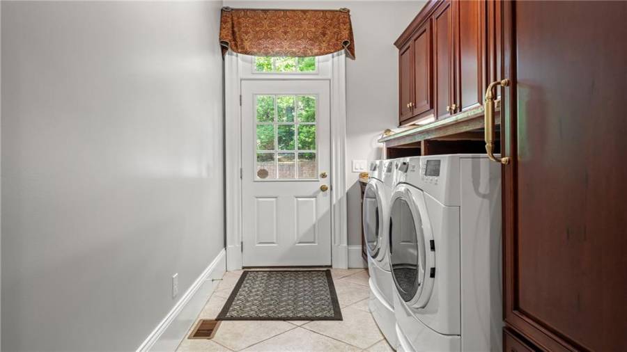 Laundry room with exterior entrance.  Washer and Dryer can remain with the home.