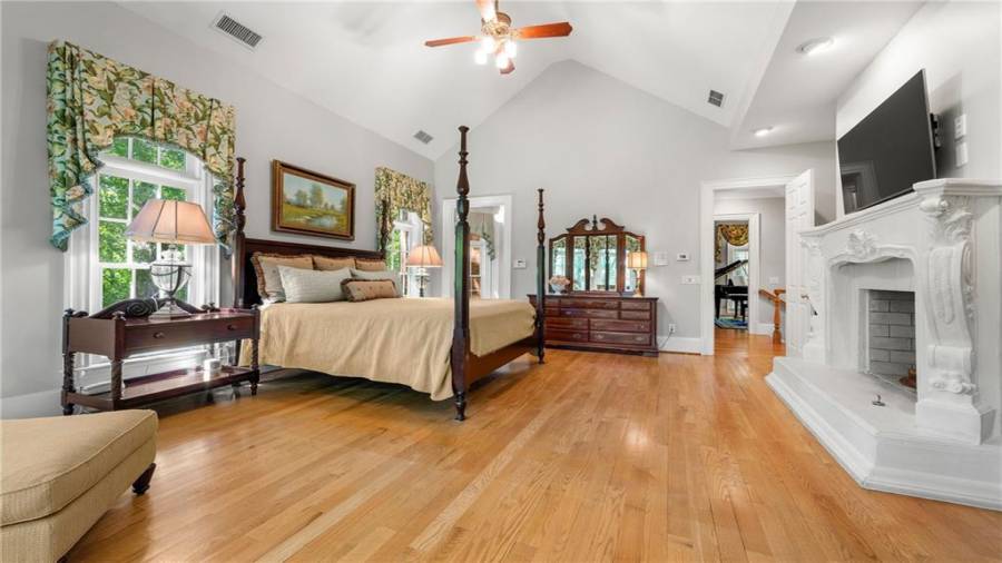 More beautiful hardwood floors, a stunning gas fireplace and cathedral ceiling.