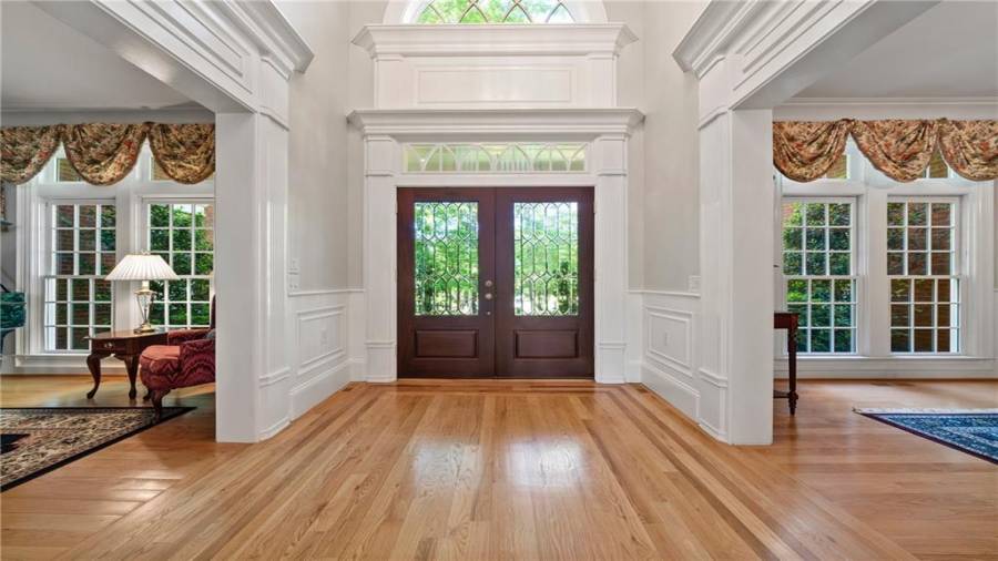 Look at the incredible woodwork and architectural details of the entry doors.  From this viewpoint, on the right is your dining room and to the left is your music room or a small living room....large windows in both.