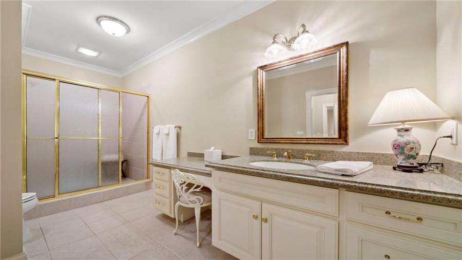 Large bath with dressing table and walk in shower.