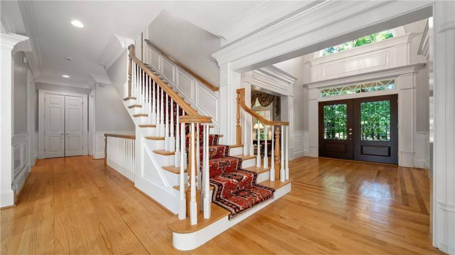 Look at how the main floor flows seamlessly from room to room.  All stairwells are nice and wide with this one leading to the upper level bedroom suites and home office.