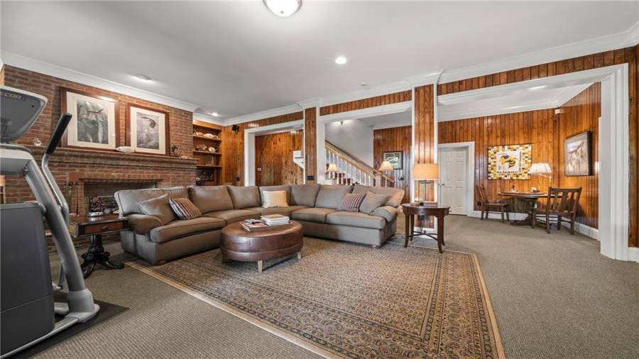 Terrace level den with brick fireplace.  Off this room there is an abundance of storage space and a separate 2 car garage with its own driveway.