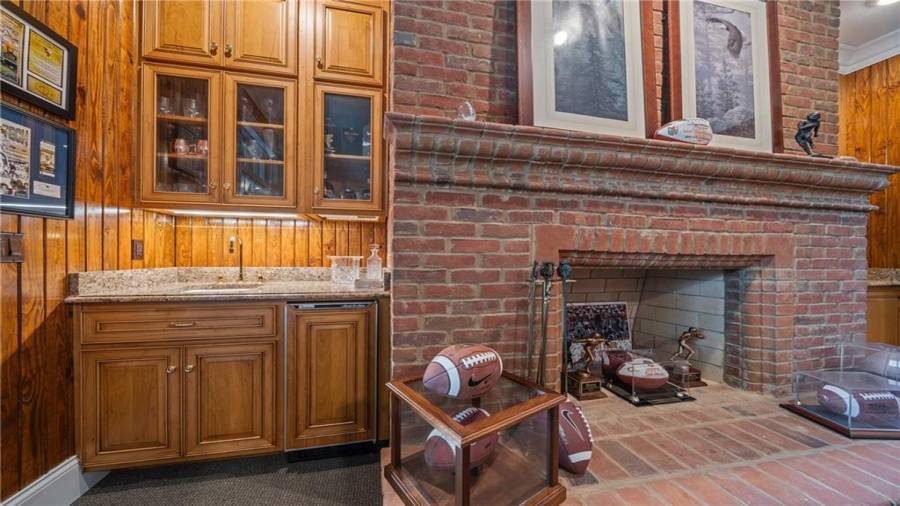Close up of the fireplace and the wet bar with custom cabinetry.
