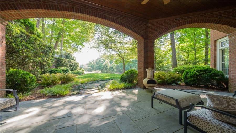 Terrace level patio with stone pathway to lush gardens!