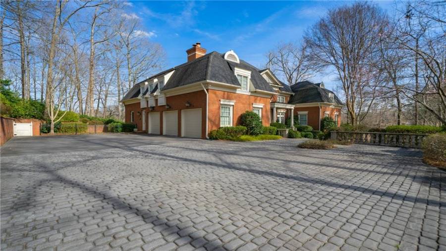 Three car garage, main level entry.  Also...look at the parking pads to the right.  And...look at the brick pavers!