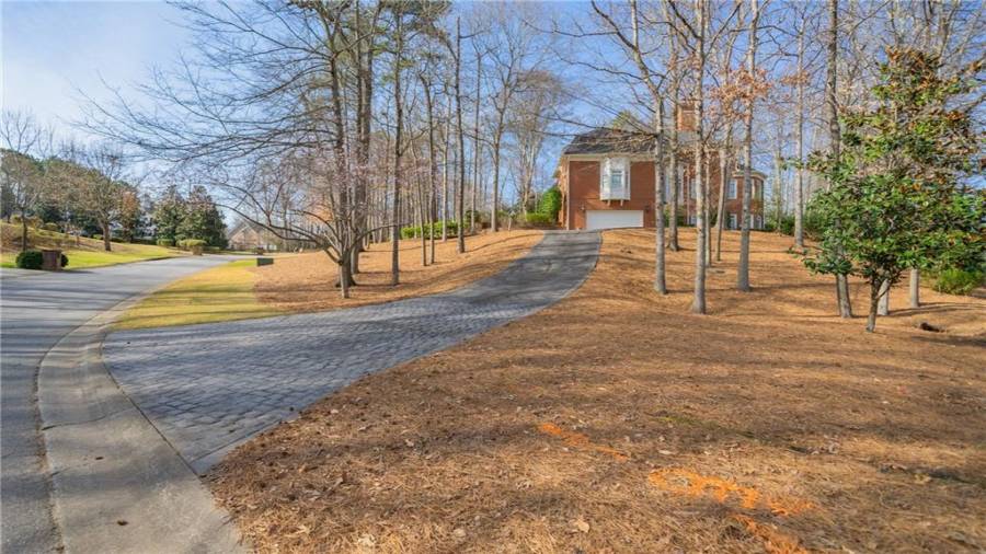 The earlier shot showed the 3 car garage on the main level.  This is an additional driveway with a 2 car garage for the lower level.  So you have a total of 5 garage spaces.  Perfect situation for a live-in on the lower level.