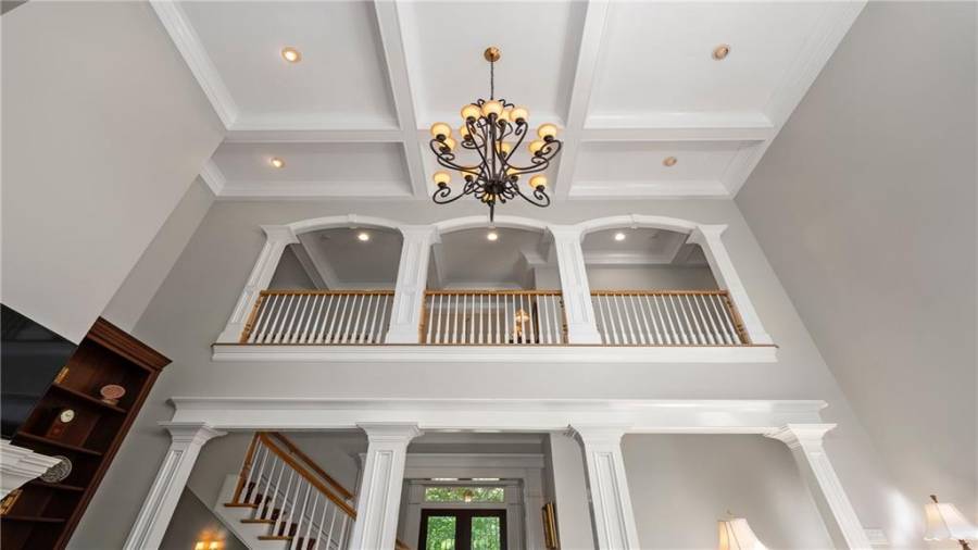 Another viewpoint - again notice the chandelier...remains with the home!!  The coffered ceilings and woodwork are truly incredible.