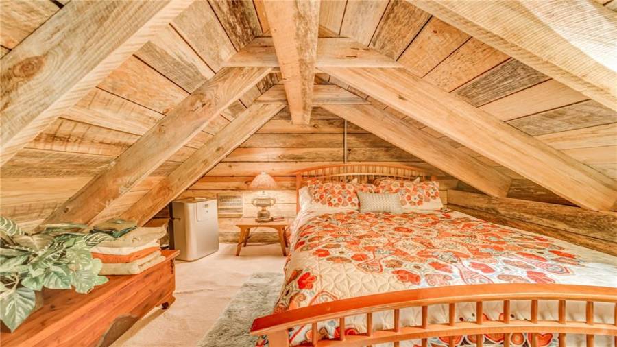 Full size bed in loft of cabin