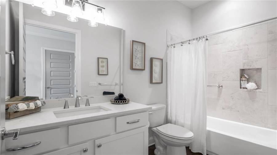 Guest Bath is located next to the Front Bedroom.  This Beautifully Appointed Full Bath has all the Bells and Whistles