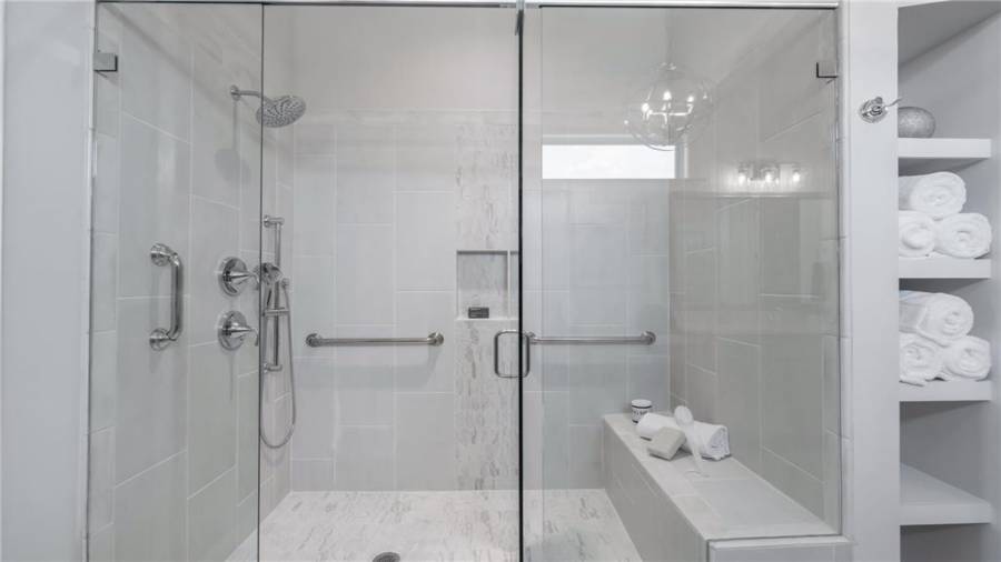 Frameless Shower Enclosure with Tiled Bench.  Safety Bars, Dual Shower Heads and a custom built in Shampoo Niche finish out this Amazing Shower.......