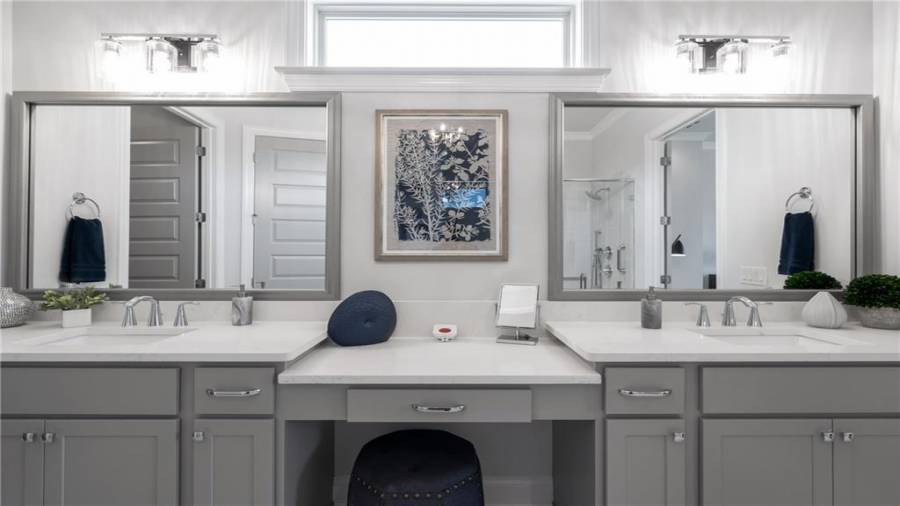 Elegant Framed Mirrors off set the Dual Vanities.  The Transom Window allows Natural Sunlight to Filter In.....