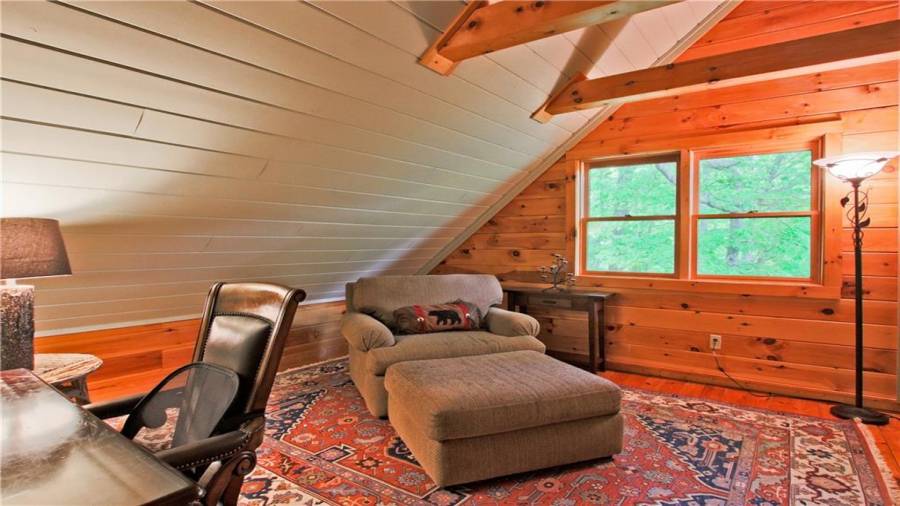 The loft area features a reading nook or home office. The loft area also has a half bath and another flex space that could either be a home office or over flow for guests.