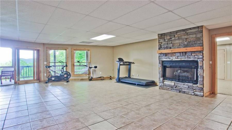 The great views of this home are not missed on the terrace level! This level features a huge recreational room which could also be used as a den or a media area. It has its own fireplace.
