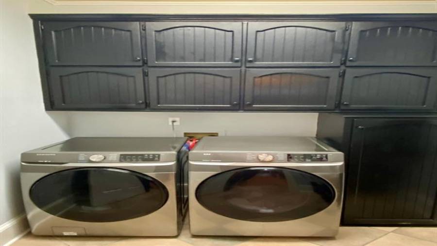 The Laundry Center is tucked away with built in Cabinets for storage