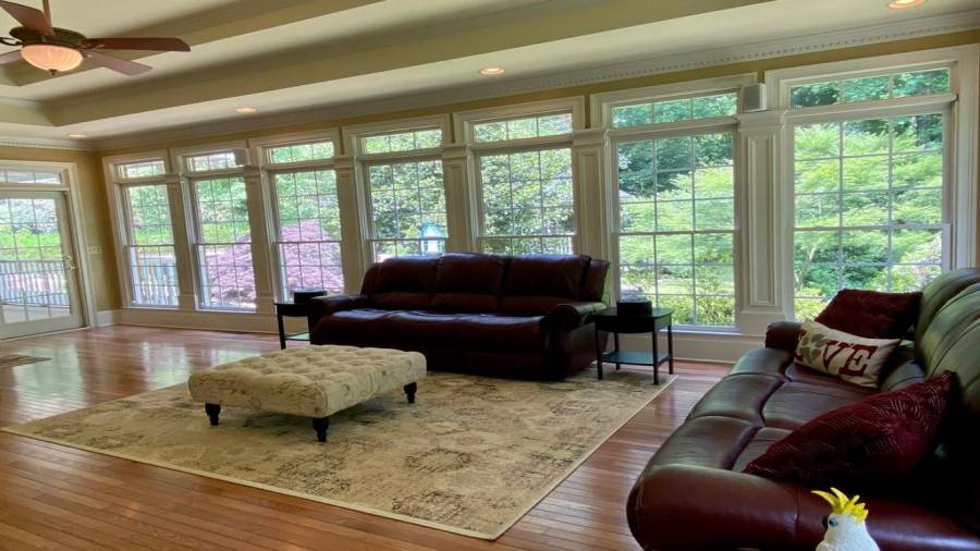 The Sun Room provides a view of the  back yard and the pool