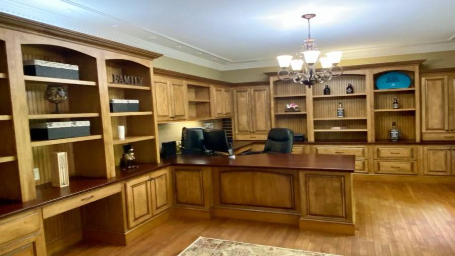 To the right, you will find the Office, complete with beautiful cabinetry