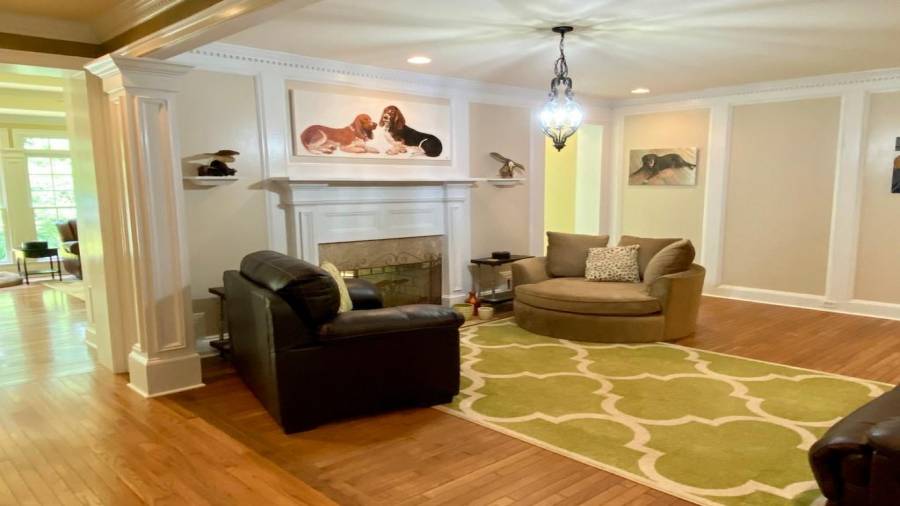 Walking down the Hallway, you come to the Family Room with a 2 Sided Gas Log Fireplace