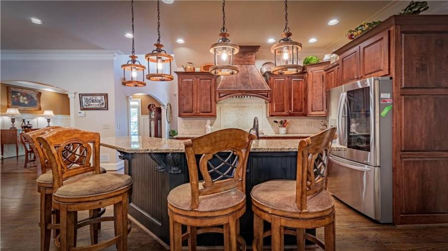 Kitchen with cherry cabinets, granite counters and stainless steel appliances.