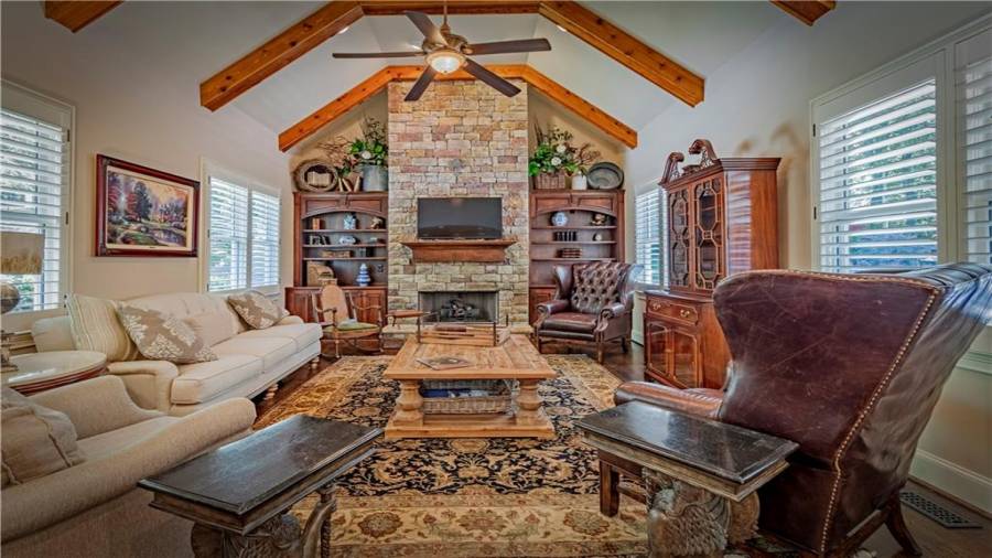 Keeping Room/Family Room off Kitchen with beams and stacked stone fireplace.