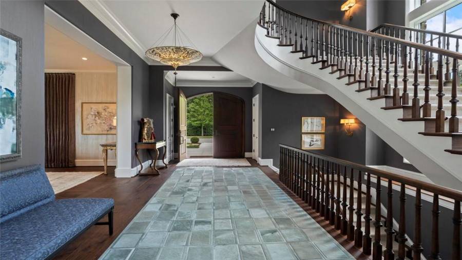 Foyer opens to a multilevel staircase.