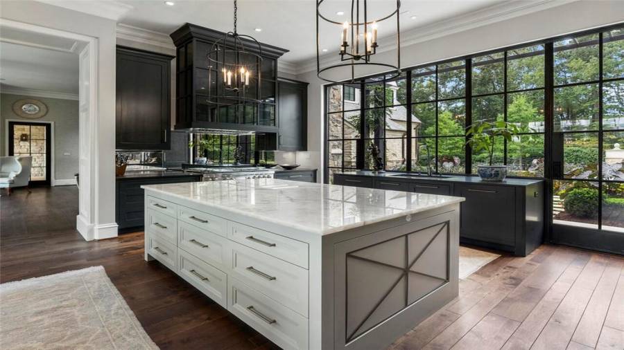 Doors that open out to garden allow sunlight to flow throughout the kitchen and breakfast room. Kitchen leads into the family room.