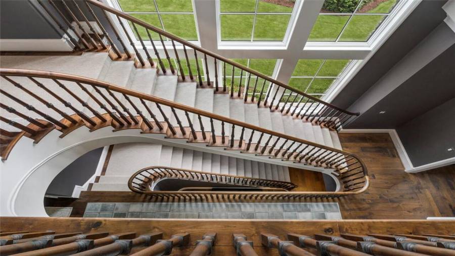 Incredible stair design down to the terrace level and filled with natural light from the wall of windows.