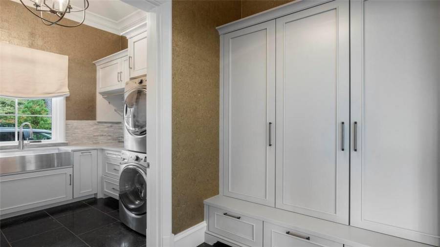Main level laundry and mudroom next to garages.