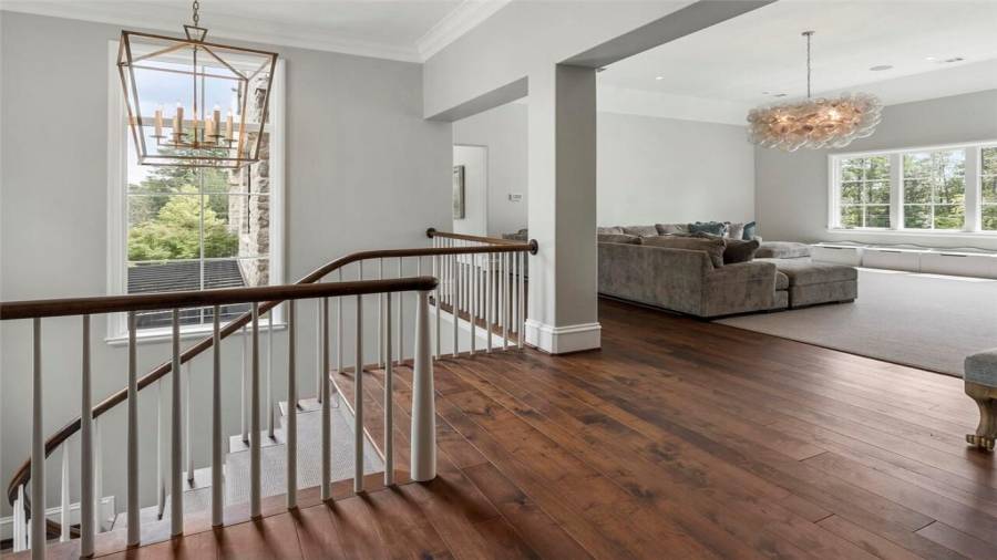 Second staircase leads down to main living spaces.