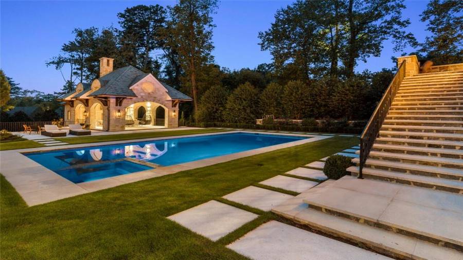 Pool house with motorized screens, firepit, bath, kitchen and office below.