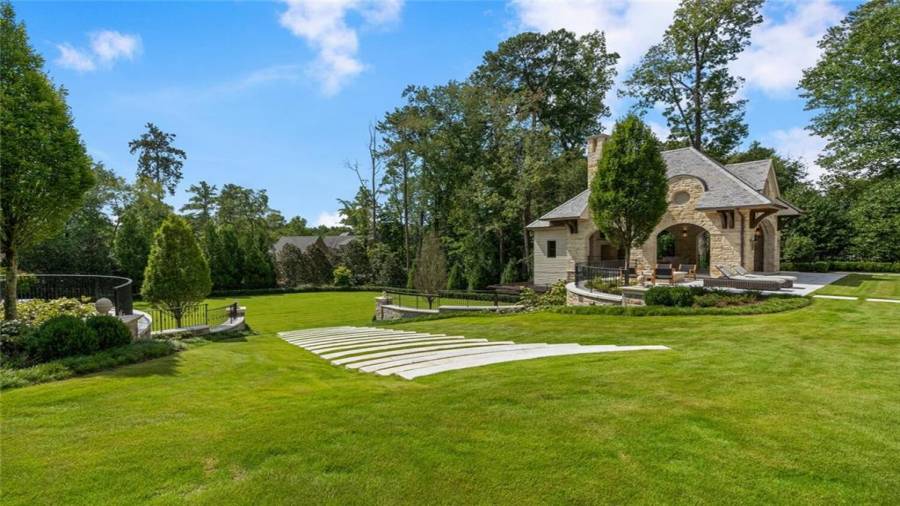 Massive lawn around the pool and beyond the pool house.
