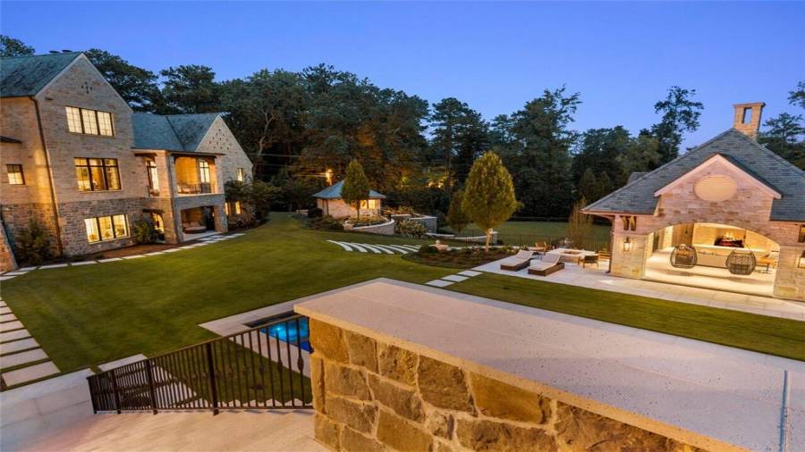 Steps lead down to the pool and pool house.