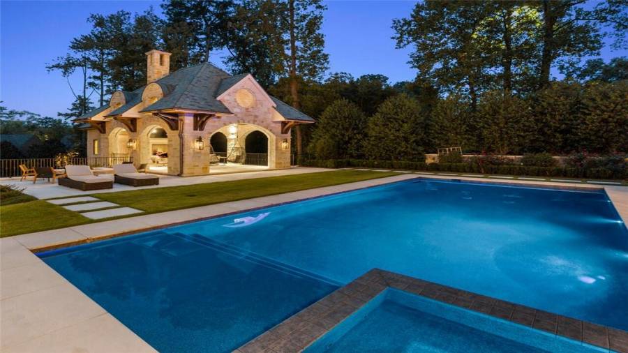 Pool house with motorized screens, firepit, bath, kitchen and office below.