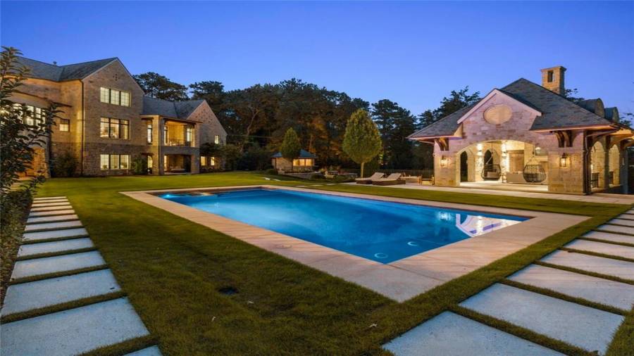 Stone surrounds the pool and spa.