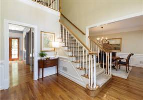Inviting 2-story foyer is flanked by formal dining room and home office.