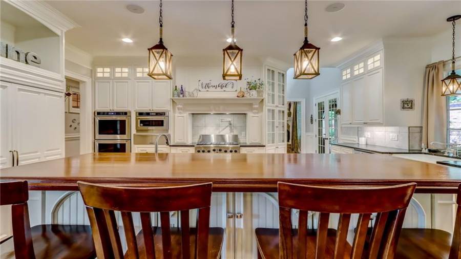 Cherry countertop island seating.