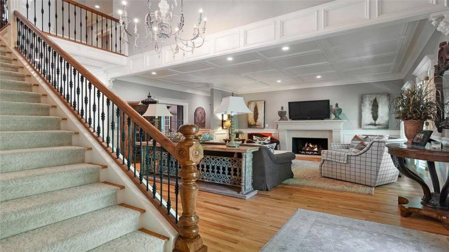 Two story light drenched foyer greets your guests