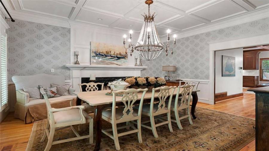 Updated chandelier, coffered ceiling & stately f/p