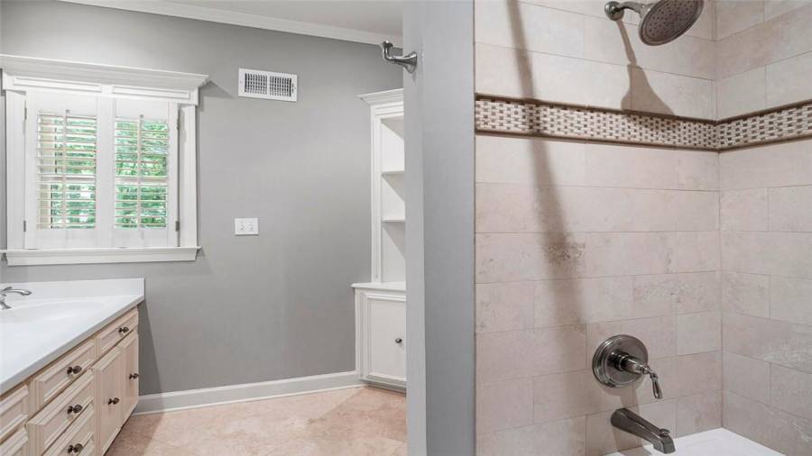 Full upstairs hall bath has plenty of storage