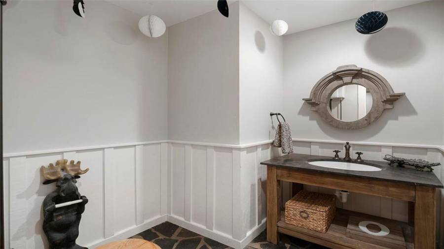 Terrace level half bath w/wainscoting & blue stone