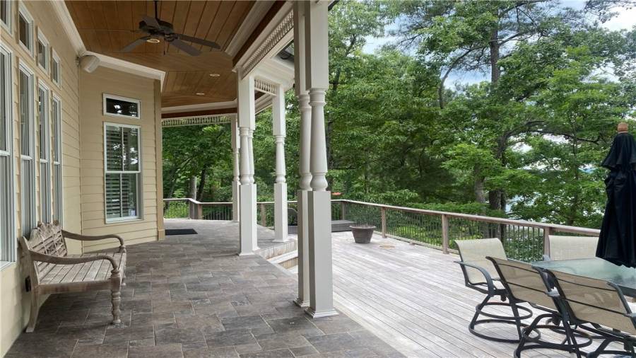 Access the covered porch from the living room, dining room and kitchen. Features tiled floors, trex decking and lake views galore. You can hear the sound of the waves on the shore. What a tranquil place to sit, relax, and enjoy nature. Fun and all the sun.