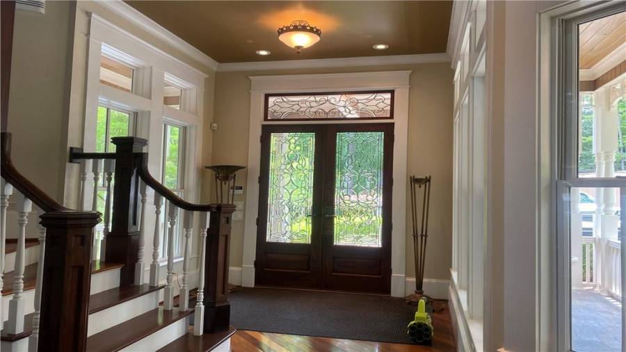 Entry foyer will impress you with this leaded front door. Wall of windows overlooks front porch and manicured front yard. 3 car detached garage.