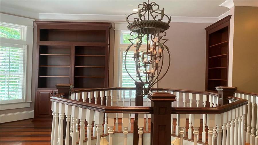 Library reading area on the upper level overlooking private front yard. All the shelving custom made and is built in. Attention to every detail in the trim work in this home. Amazing craftsmanship.