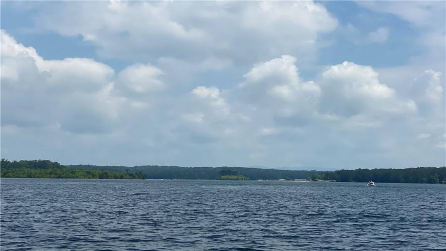 This beautiful custom home is located on the open water and offers lake and mountain views! Home faces North however you also have western and eastern views! Amazing views! Must see to appreciate the quality craftsmanship that is in this home. One of a kind for sure!!