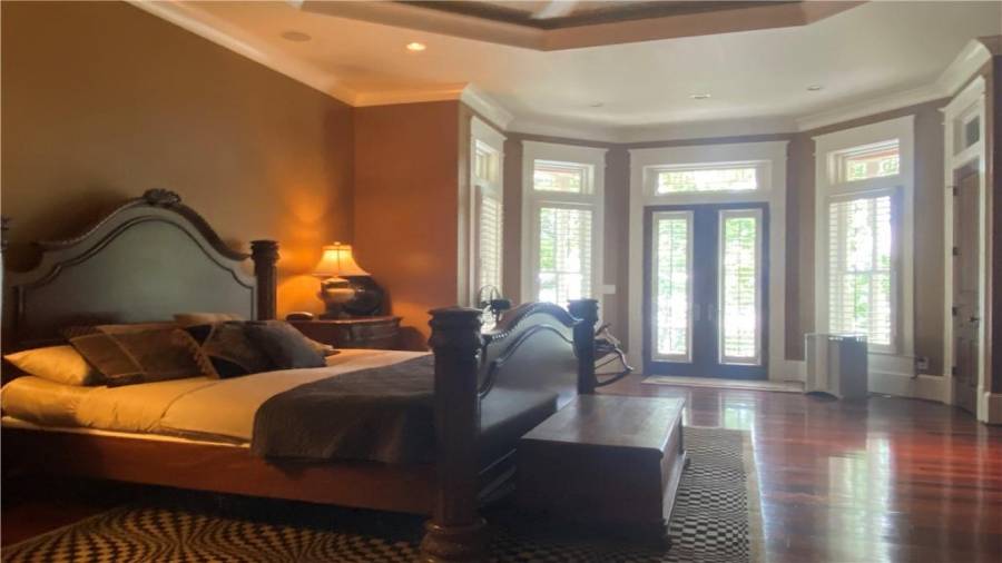 Oversized master bedroom on the main level. Double trey ceilings, wall of windows overlooking lake. Hot tub right outside the door. Sit in the hot tub and watch the moon on over the lake is wonderful.