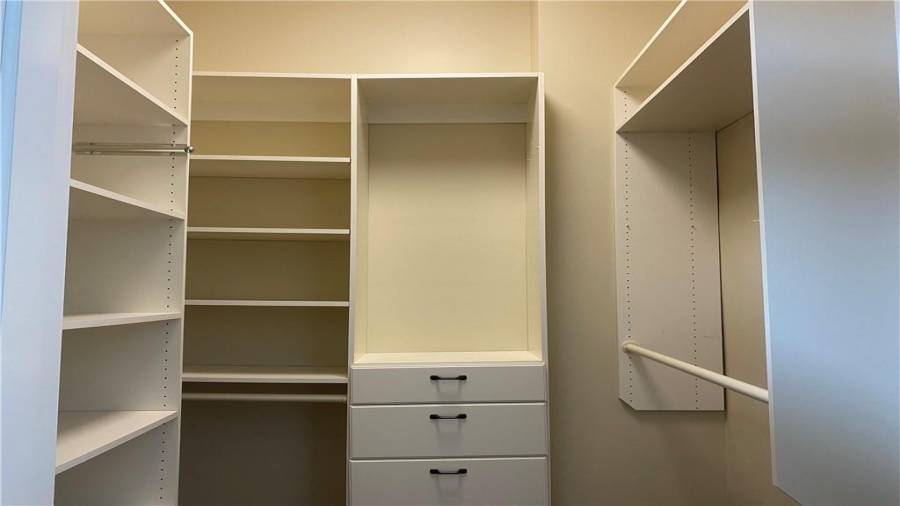 Blue en suite has built in closet shelving.