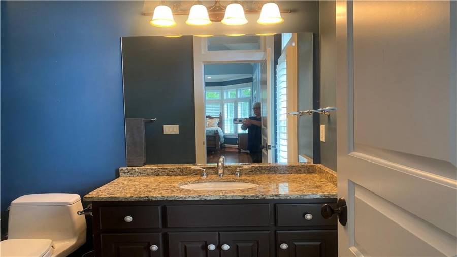 The blue room bathroom features shower tub combo, granite counter tops and fresh paint.