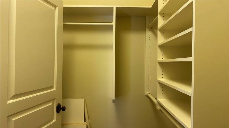 The pink room has a large walk in closet. Built in shelving offers plenty of storage space. Wow a home big enough for the whole family to get organized.