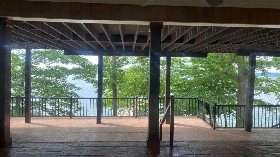 This side of the terrace level offers a direct view of the boat dock. The trees offer some shade and privacy at this lake house.  Sit down and stay a while. What a wonderful lake view.